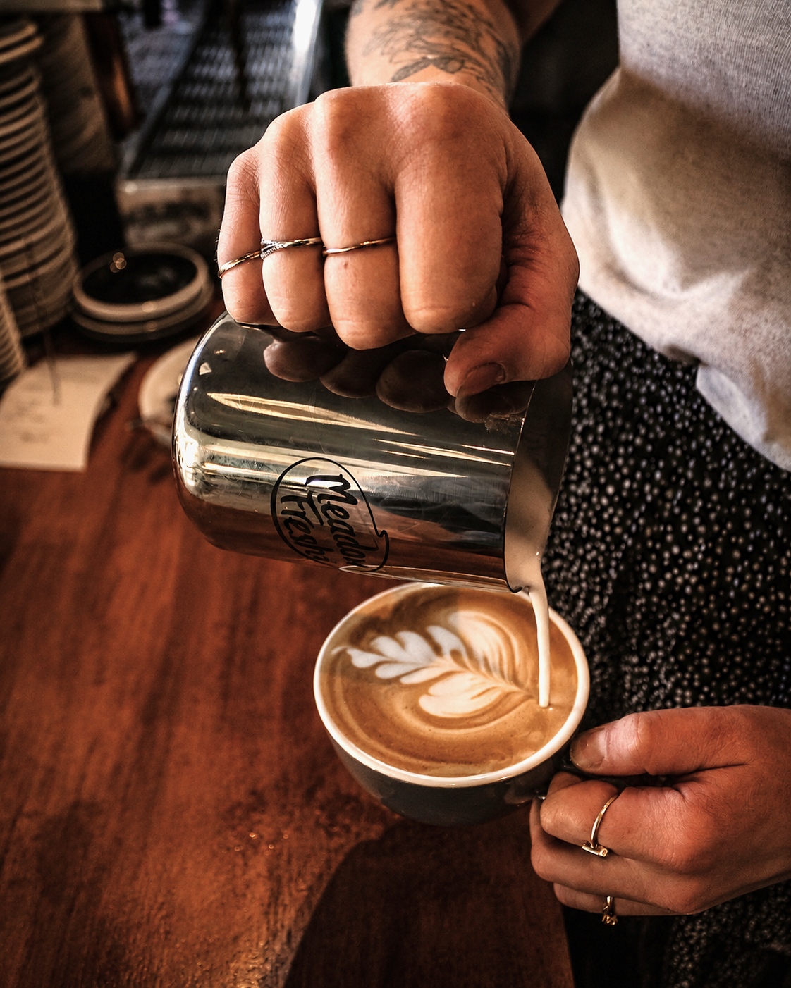 Milk being poured to make latte art at Heirloom Café