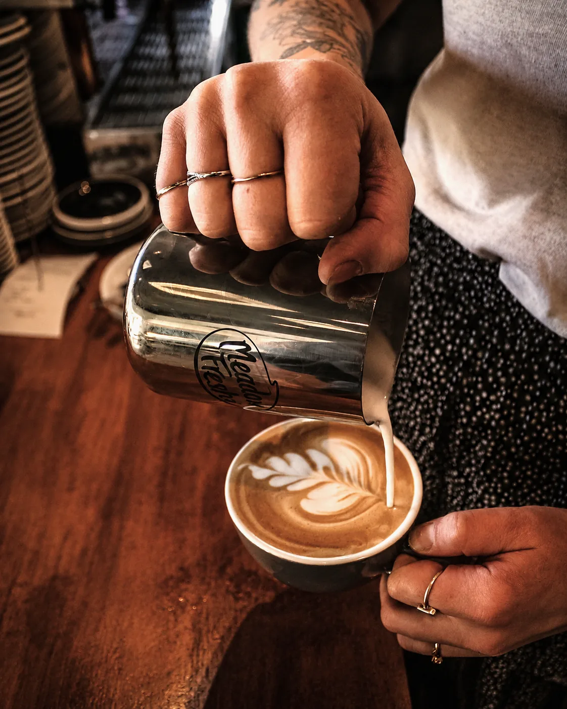 Milk being poured to make latte art at Heirloom Café