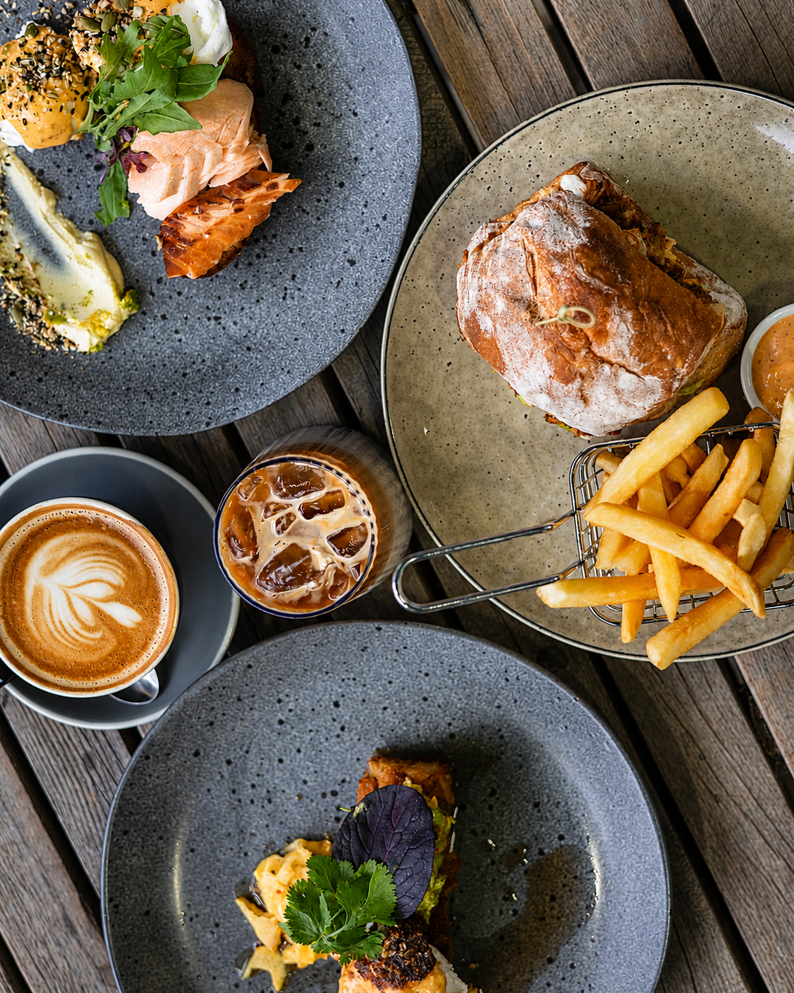 A table spread with café dishes, coffee and fries